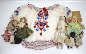 An assortment of 19th century and later dolls. Including porcelain, composite and wooden examples.