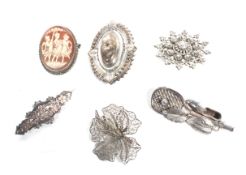 A group of six silver brooches including a cameo and several Victorian examples