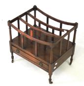 A mahogany canterbury magazine rack. With a single drawer, on casters.