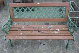 Garden bench with green painted metal ends and wooden seat.