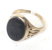 A 9ct gold and hematite intaglio signet ring.