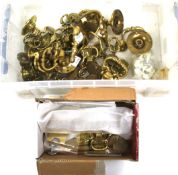 A collection of assorted brass furniture hardware.