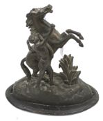 A late Victorian hollow metal figure of a young man and a horse on a plinth.