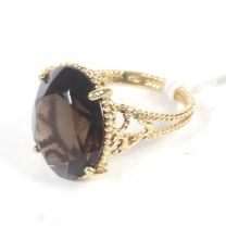 A vintage Italian gold and oval smokey quartz single stone ring.