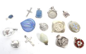 A group of 14 silver pendants including a cross,