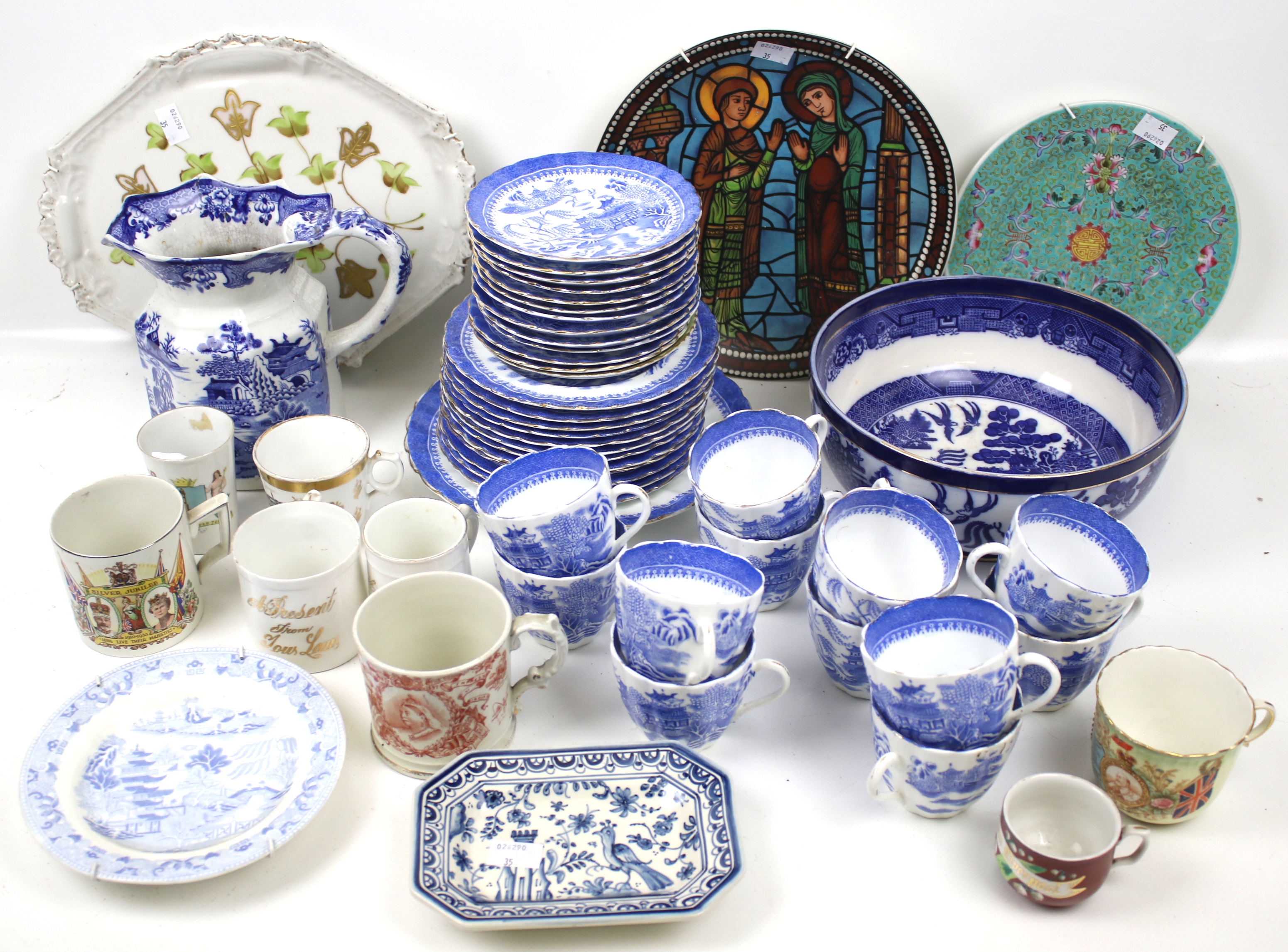 An assortment of blue and white china. Including Mason's jug and Willow pattern tea set, etc.