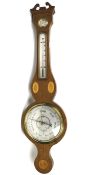 A modern mahogany wheel barometer. Inlaid with marquetry shell and fan motifs.