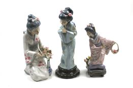 Three porcelain figures of oriental women. Comprising two Lladro and and a Casades example, Max.