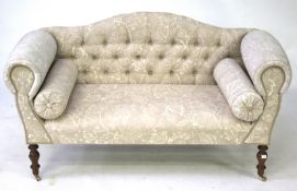 A small two seater button back sofa.