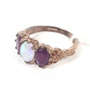 A modern 9ct rose gold, opal and ruby three stone ring in Victorian style.
