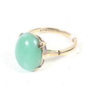 A mid 20th century gold and oval cabochon green chalcedony single stone ring.