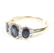 A modern 9ct gold, sapphire and diamond dress ring.