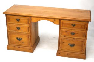A Younger Furniture pine twin pedestal dressing table with a swing mirror.