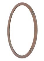 A circa 1910 oval plannished copper framed wall mirror.