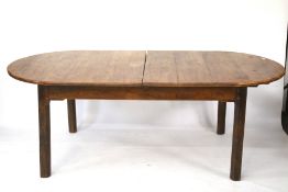 A vintage oak extending dining table. On square supports.