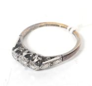 A mid-20th century gold and diamond three stone ring.