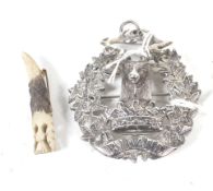 A Scottish silver Gordon Highlanders Regimental 'stag' cap badge adapted as a brooch/pendant.