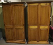 A pair of contemporary pine wardrobes.