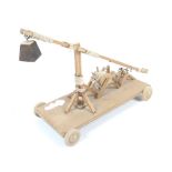 A wooden scratch built working model of a trebuchet. Made by John Fridd.