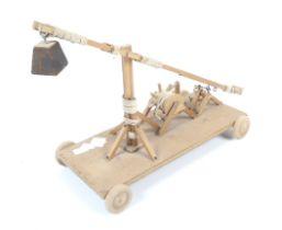 A wooden scratch built working model of a trebuchet. Made by John Fridd.