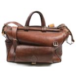 A tan leather weekend holdall bag. With handles and a detachable shoulder strap.