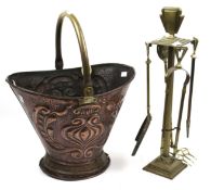 An Art Nouveau copper coal scuttle and a later fire side companion set.