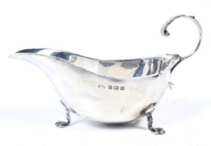 A silver small sauce boat.