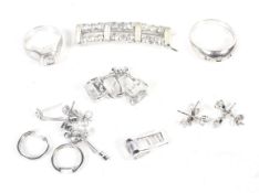 A small collection of silver and white metal jewellery including two cubic zirconia rings with