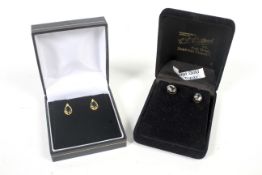 Two pairs of 9ct gold and gem-set earrings.