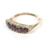 A vintage 9ct gold and garnet five stone half-hoop ring.