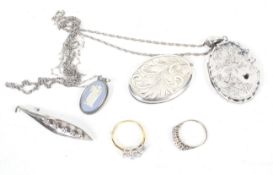 A small collection of jewellery including two silver or white metal oval lockets;