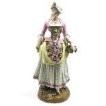 A ceramic figure of a lady, with a Meissen mark to the underside.