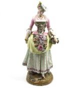 A ceramic figure of a lady, with a Meissen mark to the underside.