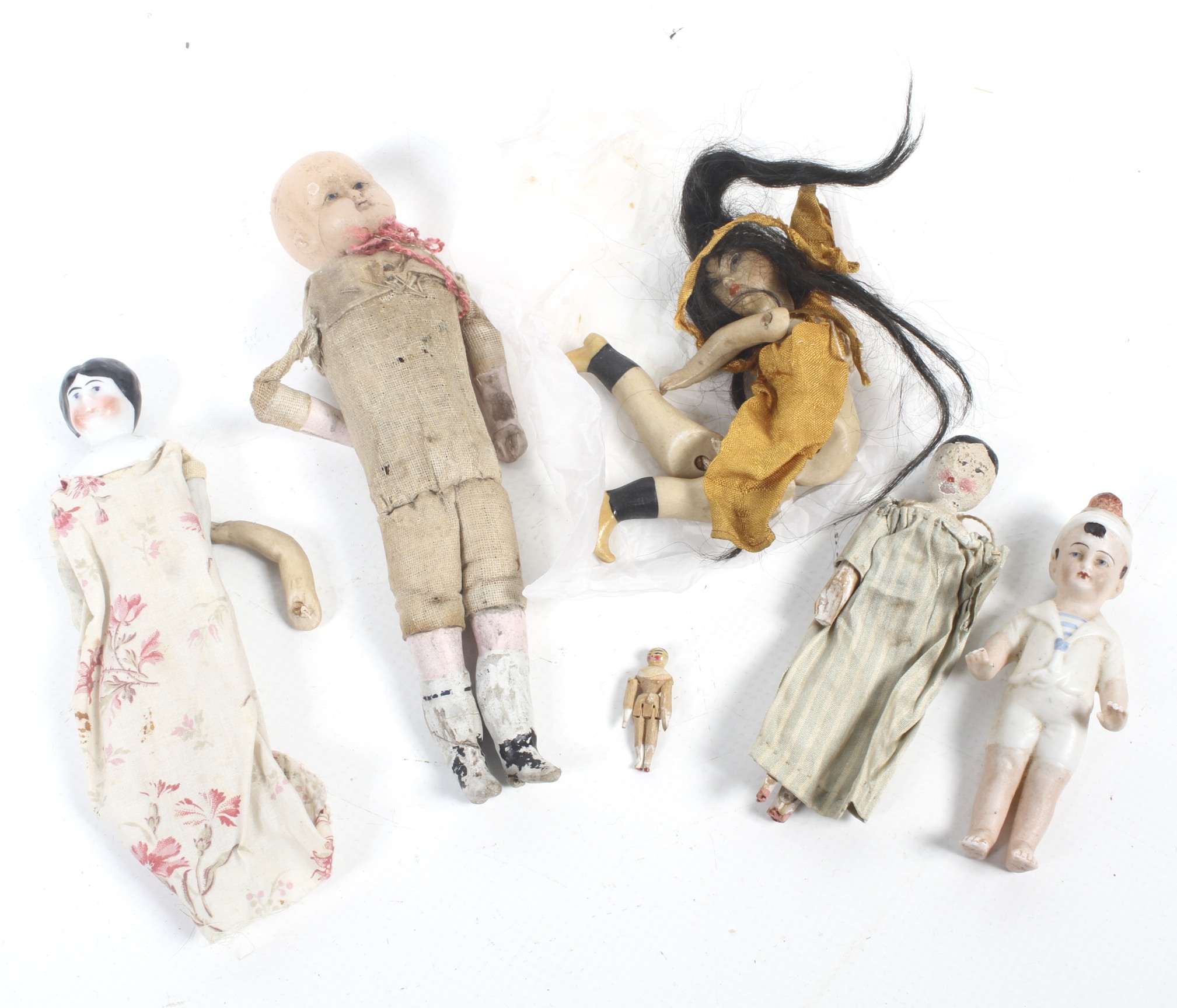A collection of small vintage dolls.