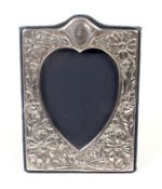 A vintage silver mounted easel-back rectangular photograph frame with a heart-shaped aperture.