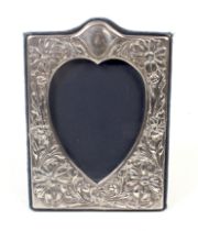 A vintage silver mounted easel-back rectangular photograph frame with a heart-shaped aperture.