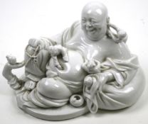 A 20th century Chinese Blanc de Chine figure of laughing Buddha with five children.