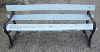 A garden bench with black painted metal ends and blue wooden seat.