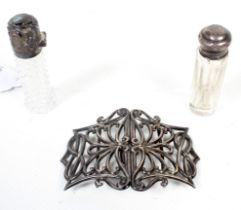 Two Victorian and later silver mounted scent bottles and a nurse's buckle.