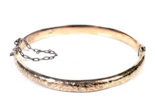 An Edwardian 9ct rose gold hollow hinged bangle.