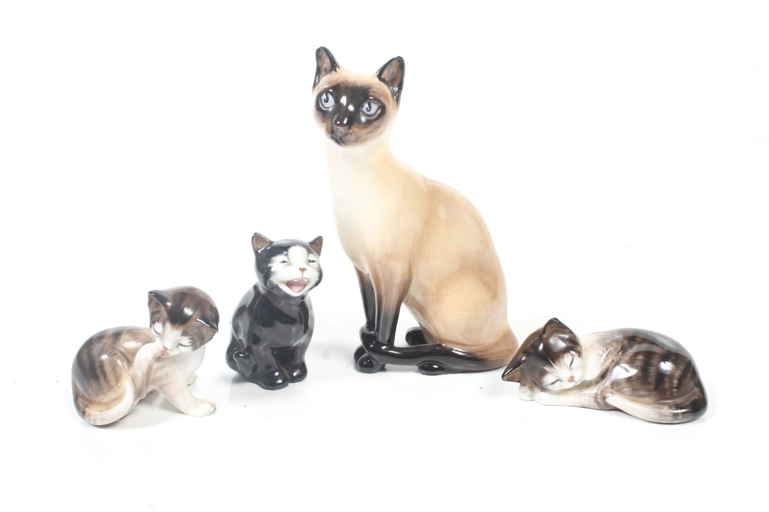 Four Royal Doulton cat and kitten figures. Including 'Lucky'. Max.