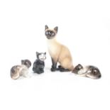 Four Royal Doulton cat and kitten figures. Including 'Lucky'. Max.