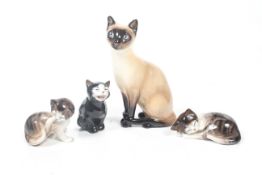 Four Royal Doulton cat and kitten figures. Including 'Lucky'. Max.