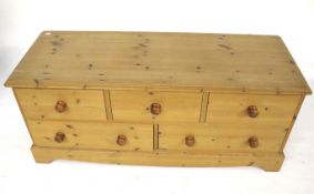 Low level pine chest of drawers. Three short over two long.
