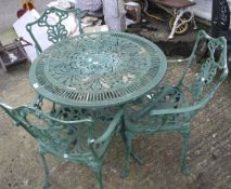 A garden table and a set of three chairs. painted green.