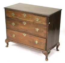 A chest of drawers. On cabriole support with brass swing handles and escutcheons.