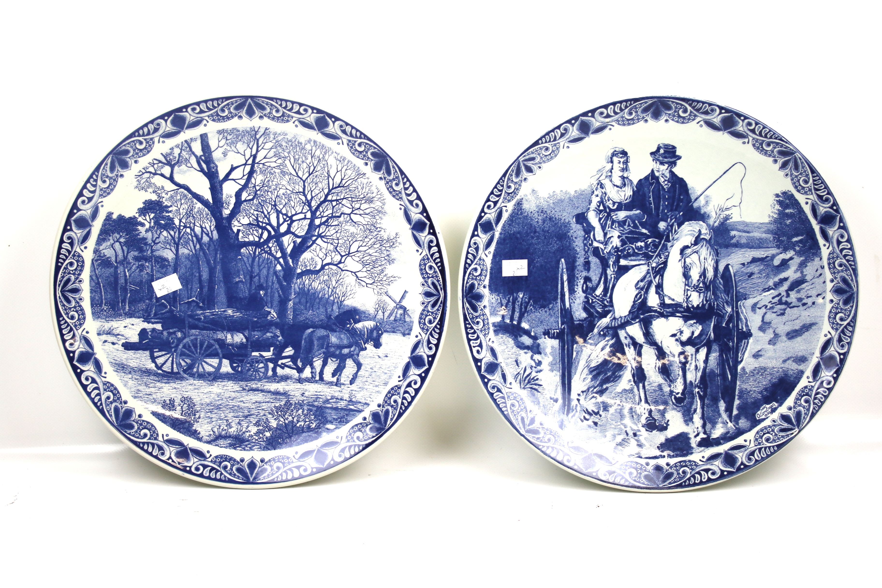 A pair of large Delft Blau chargers. Both decorated with working horses.