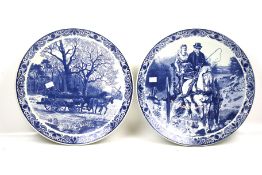A pair of large Delft Blau chargers. Both decorated with working horses.