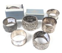 Six Victorian and later silver napkin rings in various designs.