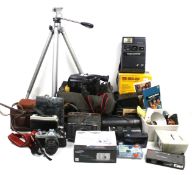 A collection of assorted vintage film cameras and accessories.